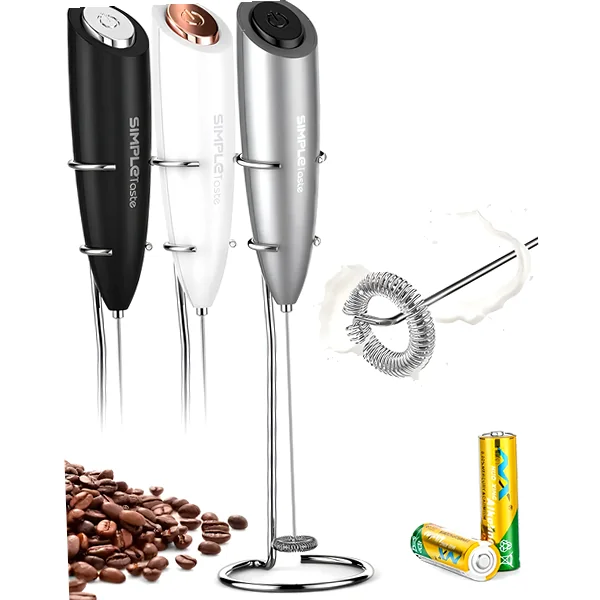 Handheld frother with stainless whisk and stand beside a latte